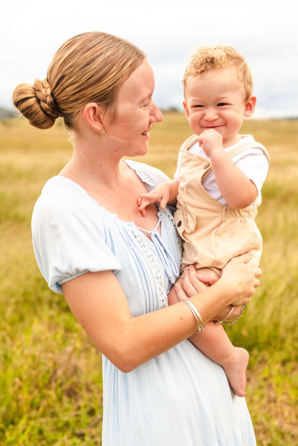 Sweet family moments captured in warm sunlight with mother and child.