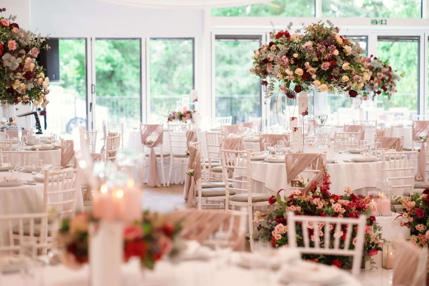 Interior wedding decor of Winstanley house red flowers tables and chairs