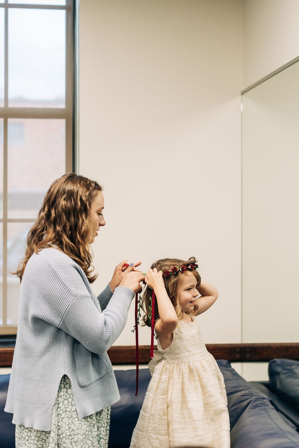 A touching moment during wedding preparations in a bright room.