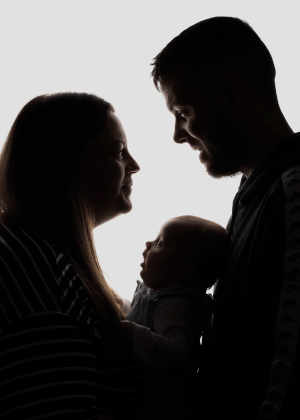 Baby looking up at mum in family photo captured by Ceredigion Family Photographer