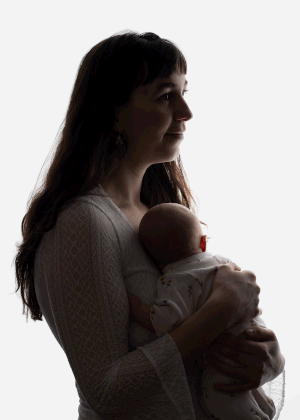 Backlit image of mother and baby during in-home newborn session in Ceredigion