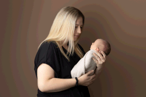 Mother looking at baby during a session with Ceredigion Newborn Photographer, Ceris Hicks Photography