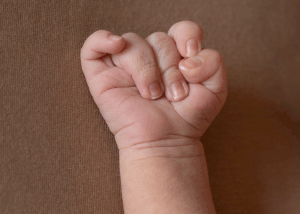 Tiny details of a newborn's hand during a session with Ceris Hicks Photography