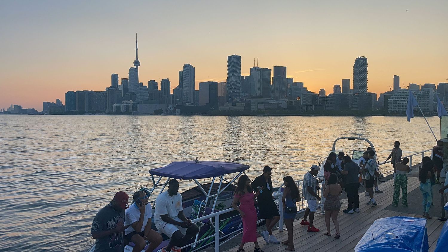Toronto city skyline silhouette view at sunset across the water.