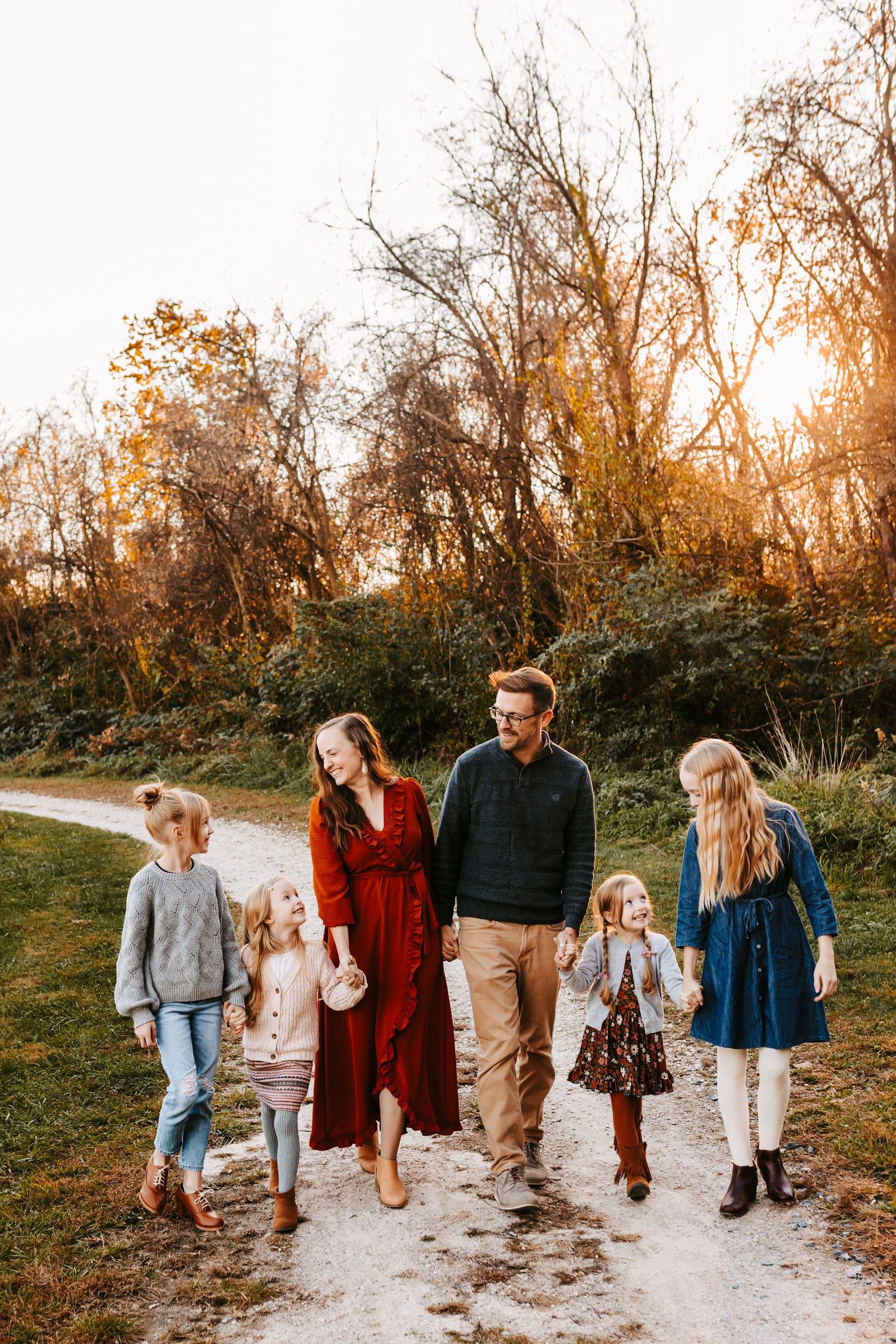 Naomi Boyer's family walking outside wearing a rust, pink, tan, and grey color palette