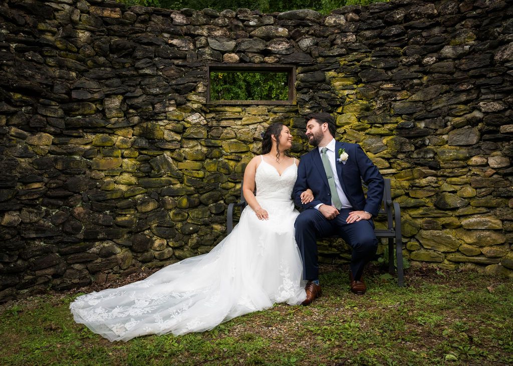 Series of wedding photos showing couple posing against rustic stone wall in garden setting.