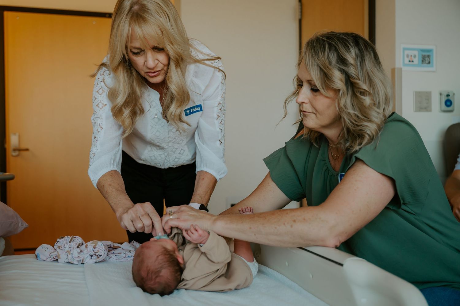 Newborn baby is attended to by family