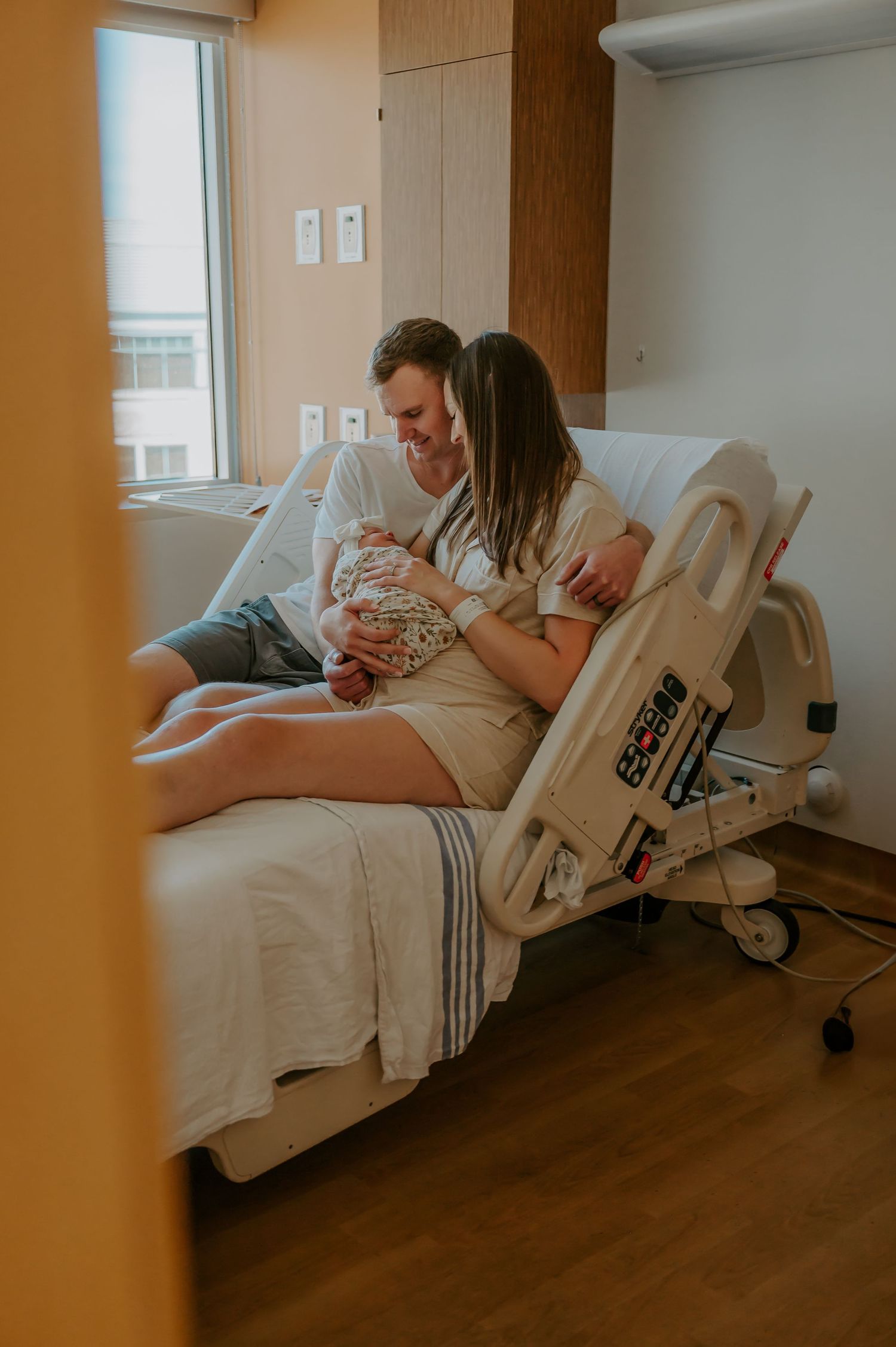 Newborn in a hospital bed with parents