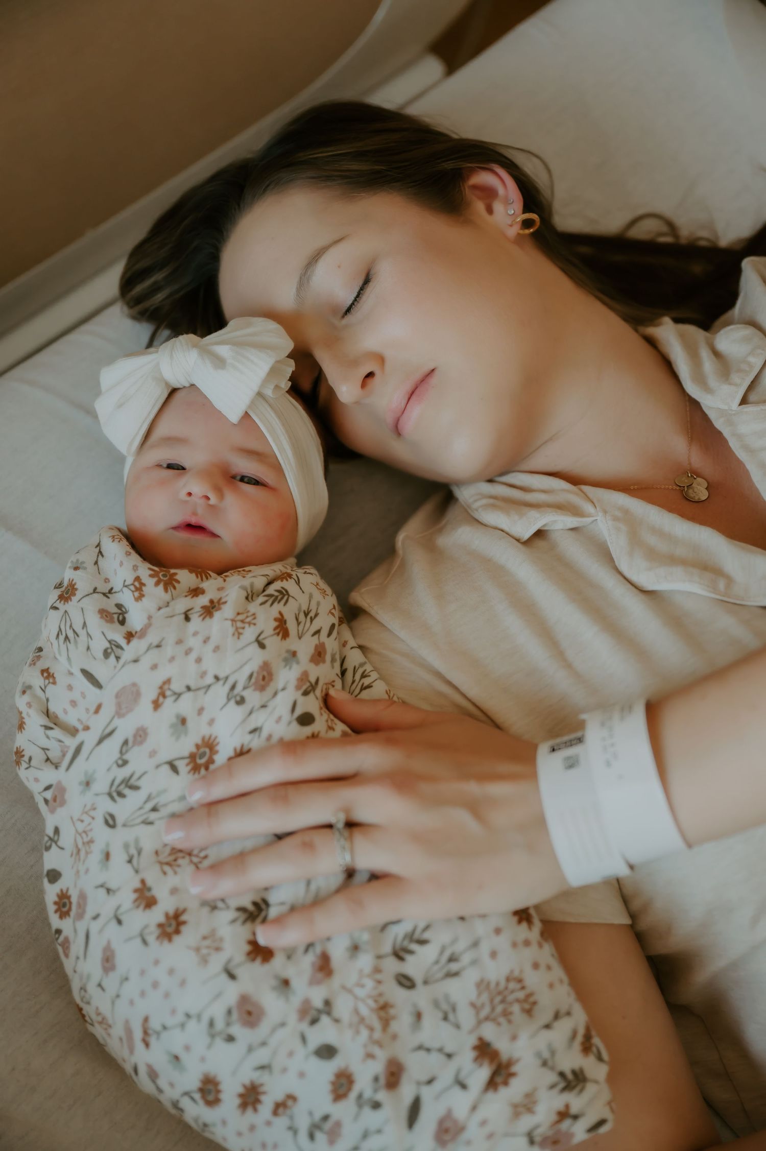 Newborn laying beside mother