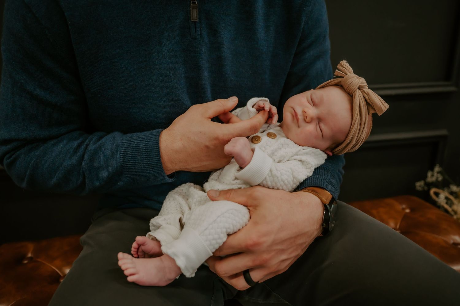 Baby sleeping while held by father
