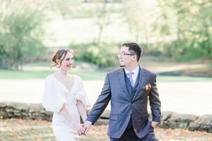 A couple shares a joyful moment together during their outdoor wedding photoshoot.