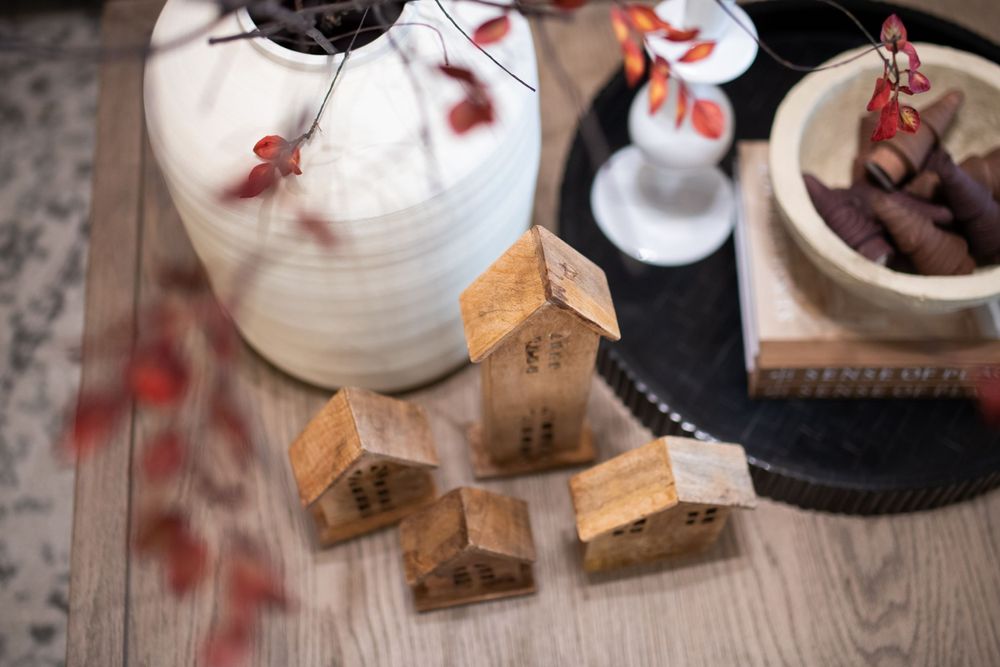 Rustic table setting with white paper lanterns and autumn decorative elements.