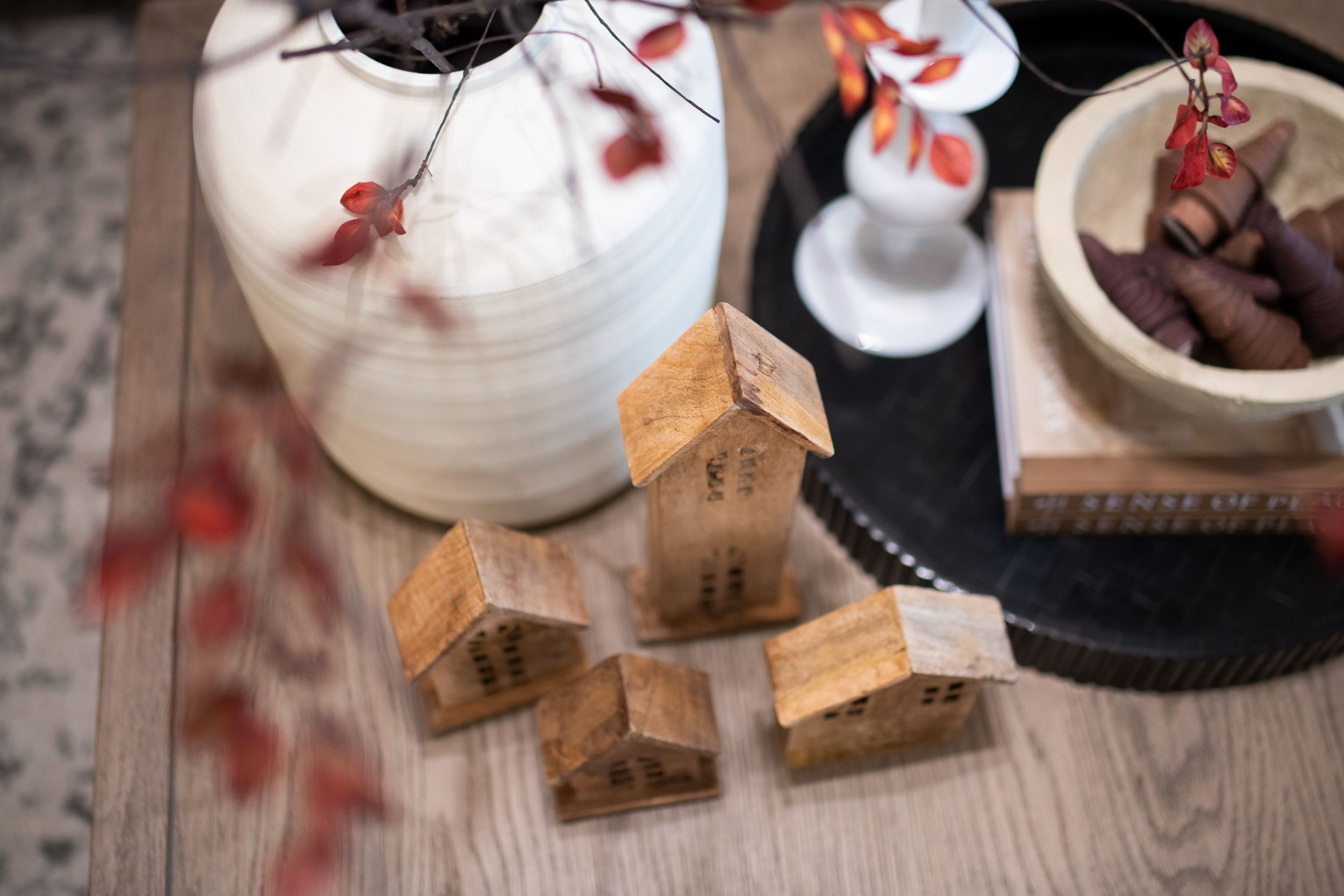 Rustic table setting with white paper lanterns and autumn decorative elements.