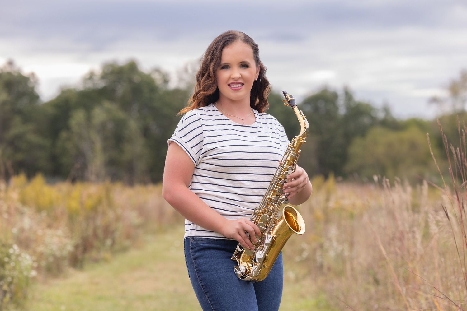 girl holding saxophone