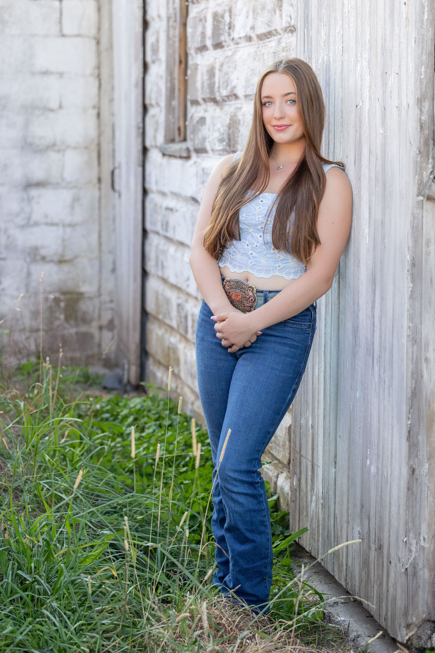 girl leaning against barn