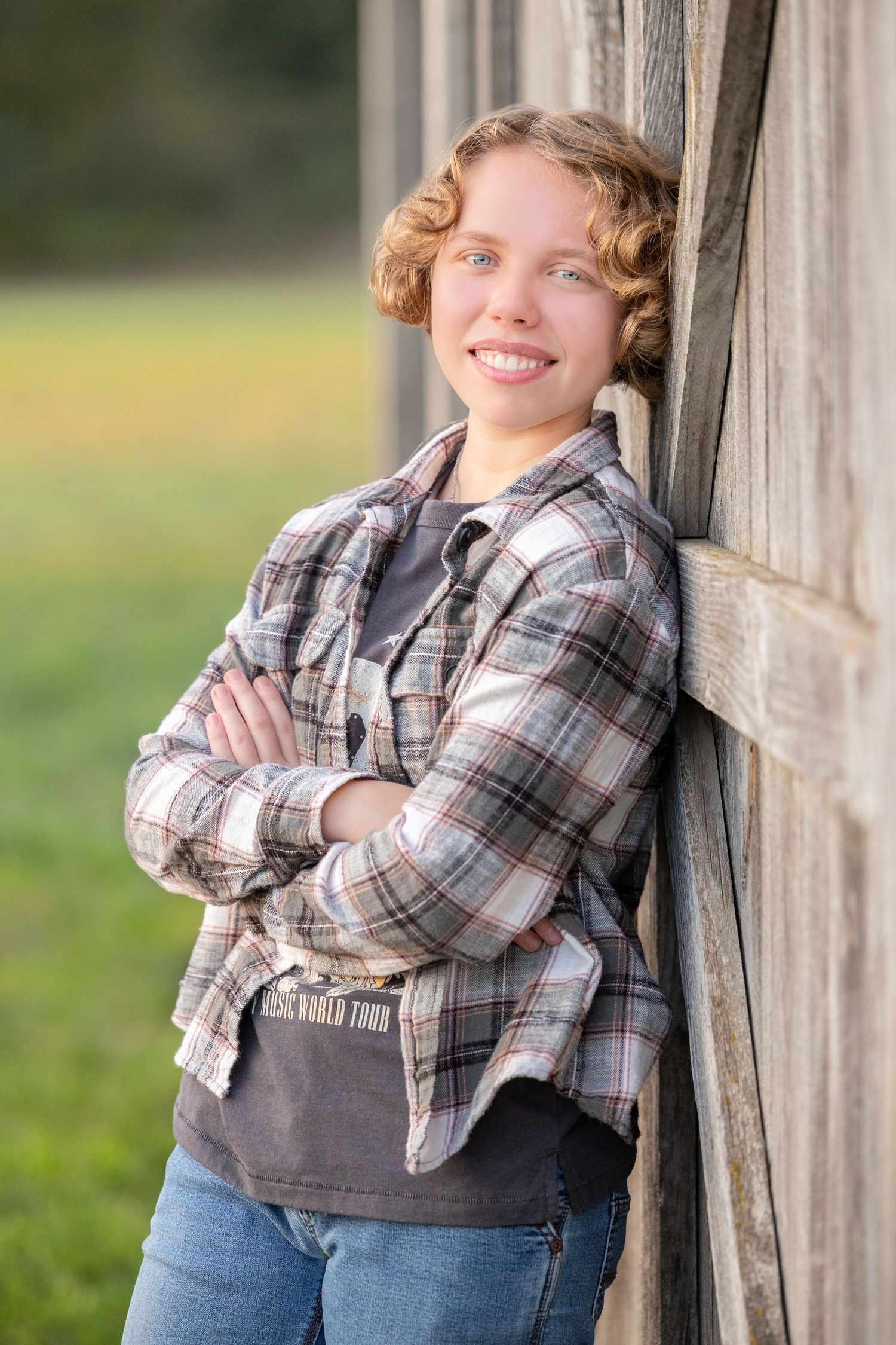 girl leaning against barn