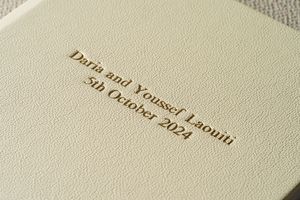 Close up view of text printed in a book showing faded brown typography on white paper.