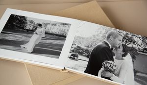 A collection of wedding photo album spreads arranged in a row showing various monochromatic and color images.