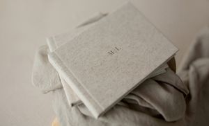 A minimalist storage box made from light gray recycled paper material holds everyday items.