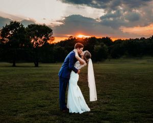 Romantic sunset wedding photos in a pastoral field with dramatic sky. Middle TN wedding photographer.