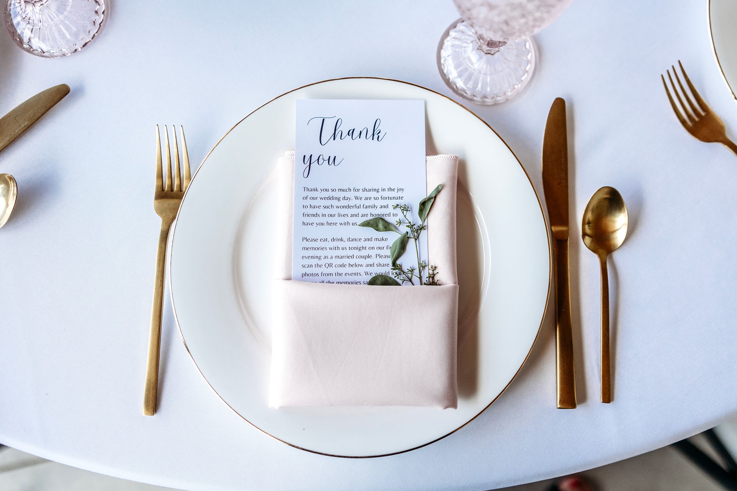 Elegant place settings with gold cutlery and white plates on light blue tablecloth.Middle TN wedding photographer.