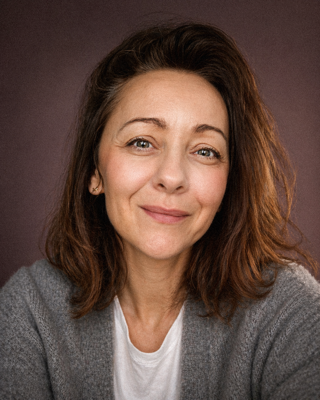 Professional studio portrait with white floral decor in soft lighting.