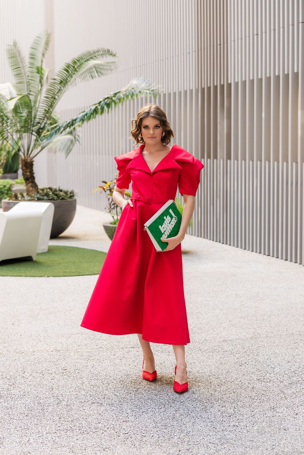A series of fashion shots showing a bright red dress styled with matching red heels in an outdoor setting.