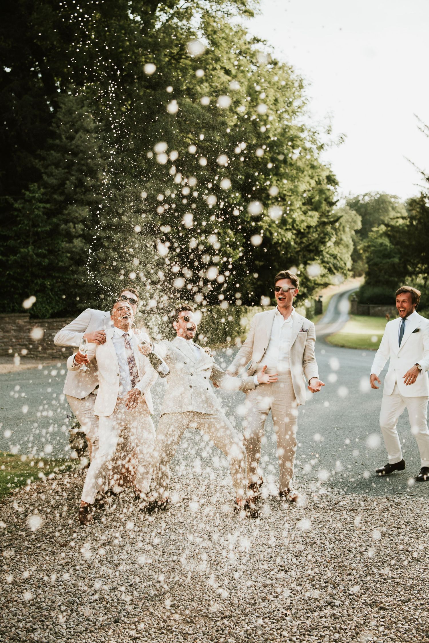 Broadfield Court Wedding Venue. Champagne Spray Photo Idea. Herefordshire wedding photography - Rosie Kelly Photography