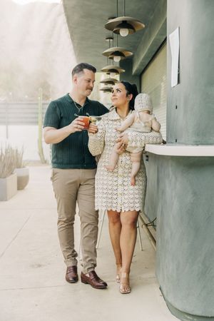 A couple shares a cocktail together while while posing for a photo at a chic Palm Springs hotel.