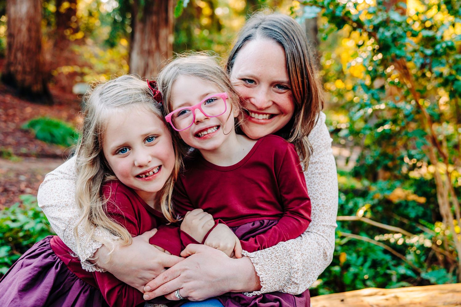 A series of candid outdoor family portraits taken in a vibrant autumn setting with golden foliage in the background.