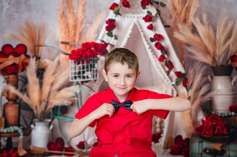 valentine boho themed with tent and roses; boy with red shirt and boy tie in broken arrow indoor photography studio