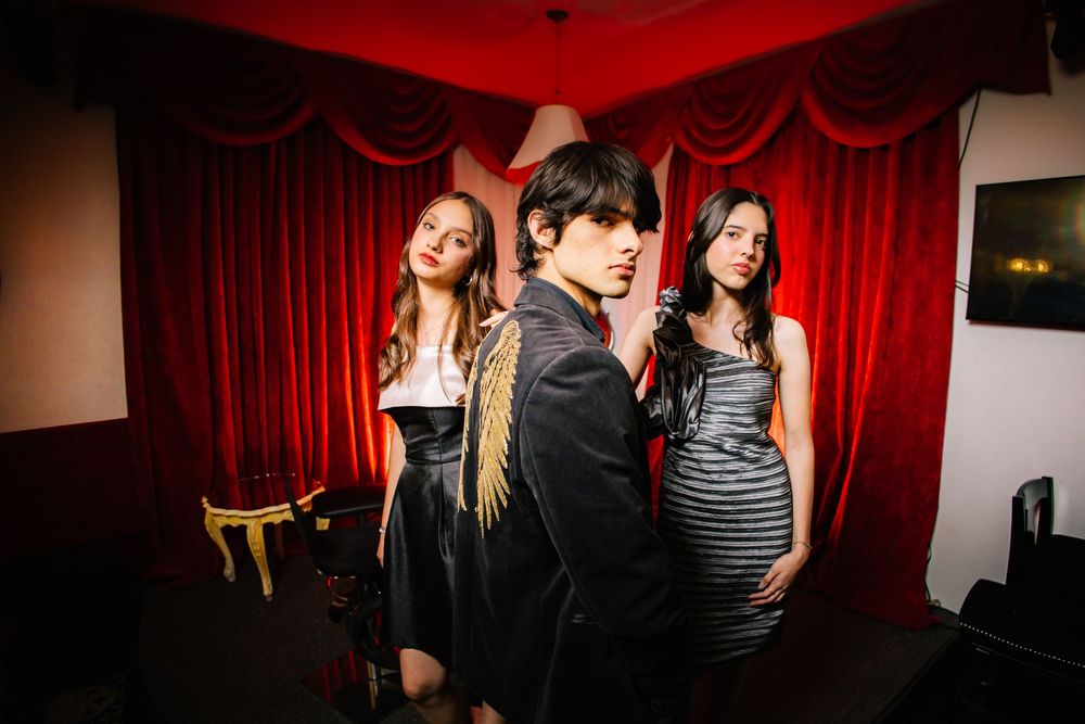 A series of five connected photos showing people in a dimly lit venue with red curtains and dark ambiance.