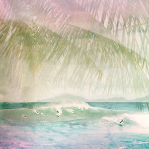 Dreamy double exposure of surfers riding waves with tropical palm trees overlay.