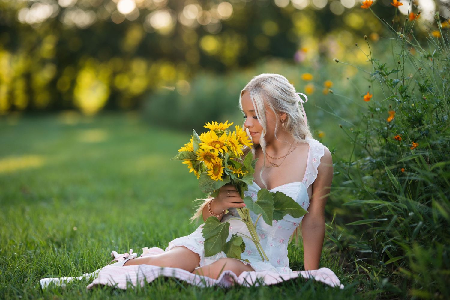 Candid outdoor photoshoot in a garden with sunflowers and golden evening light.  Middle TN senior photographer.