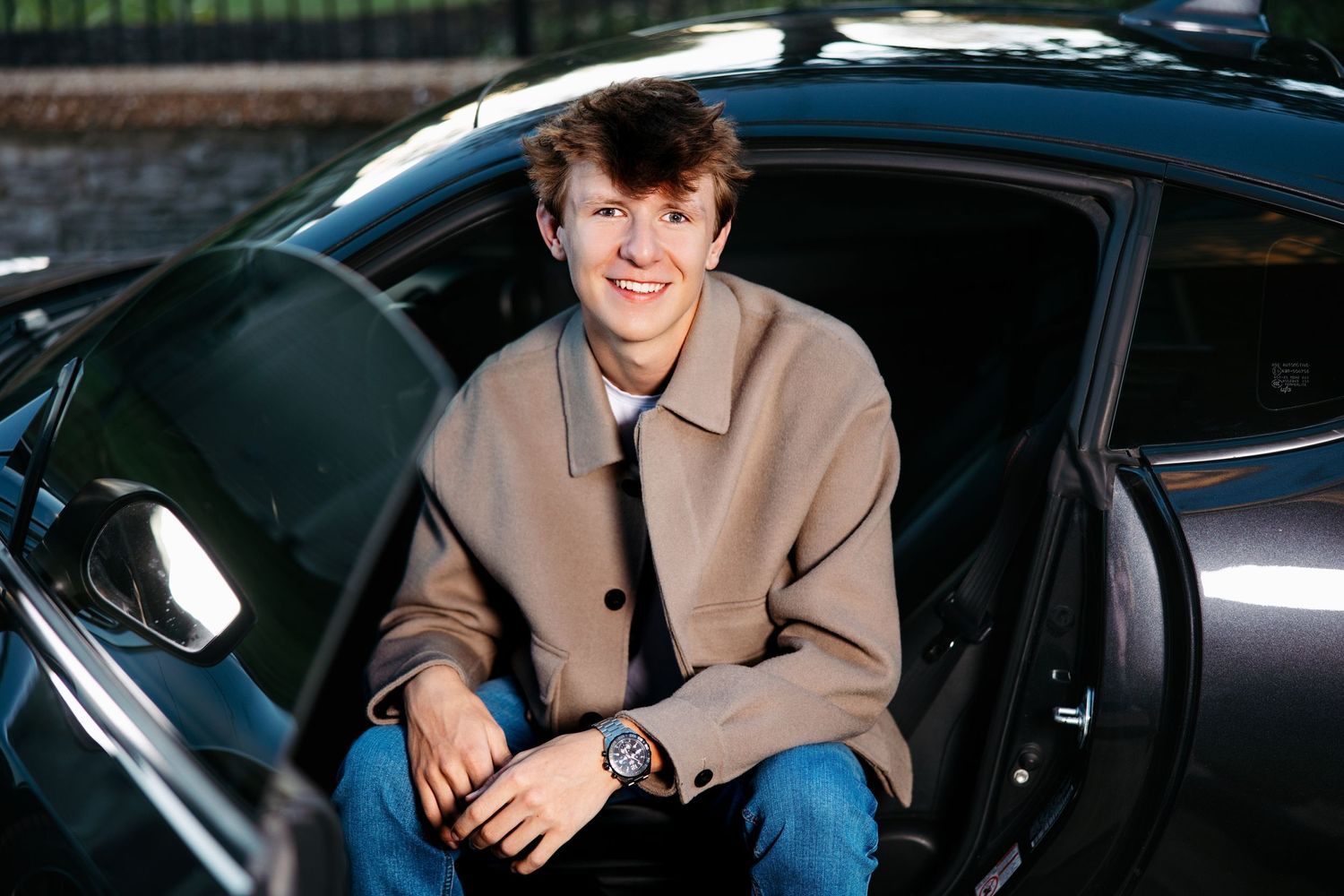 Senior guy sitting in luxury car interior with leather seats.Middle TN senior photographer.