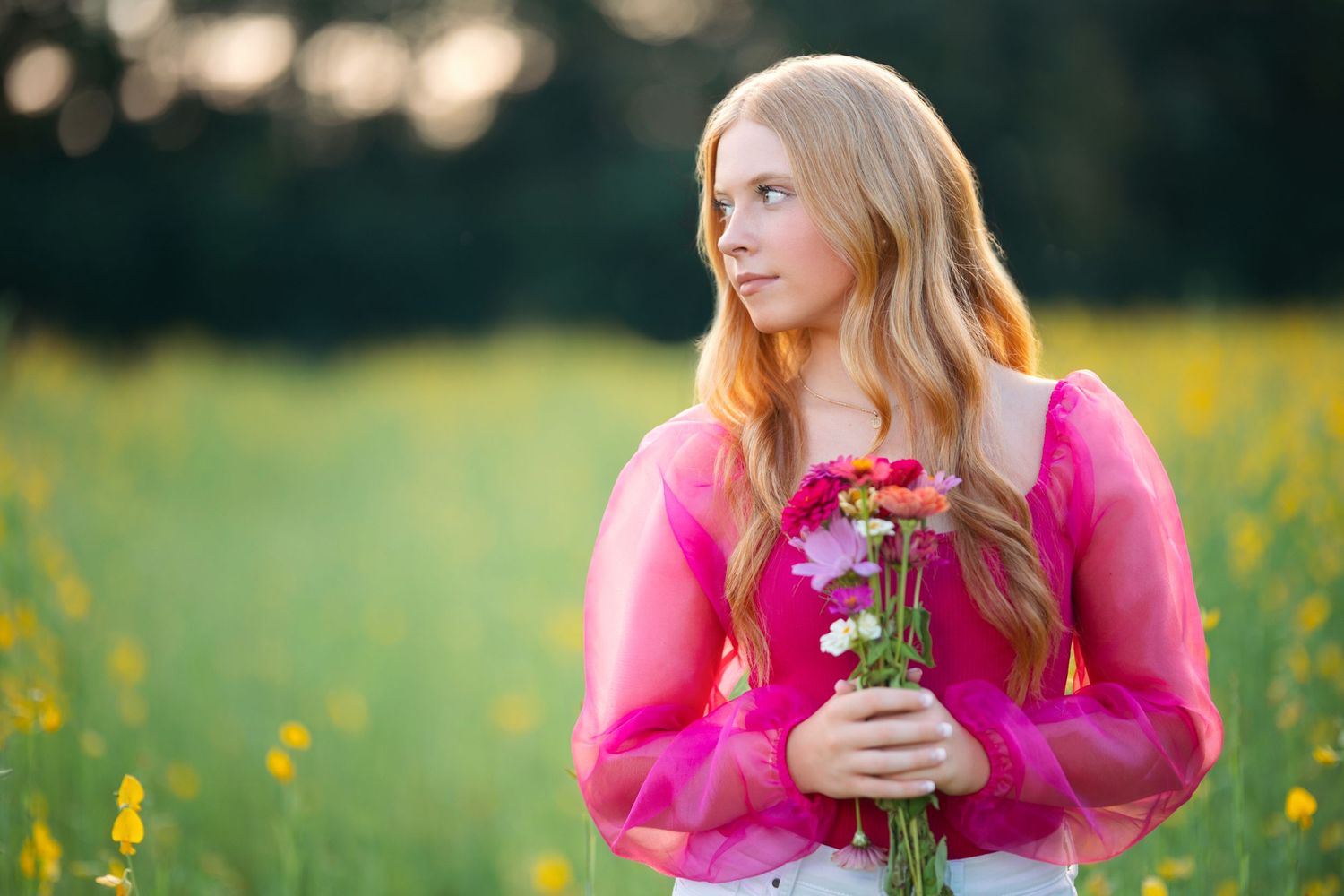 Springtime portrait session in a field of yellow wildflowers with bright pink sweater. Middle TN senior photographer.