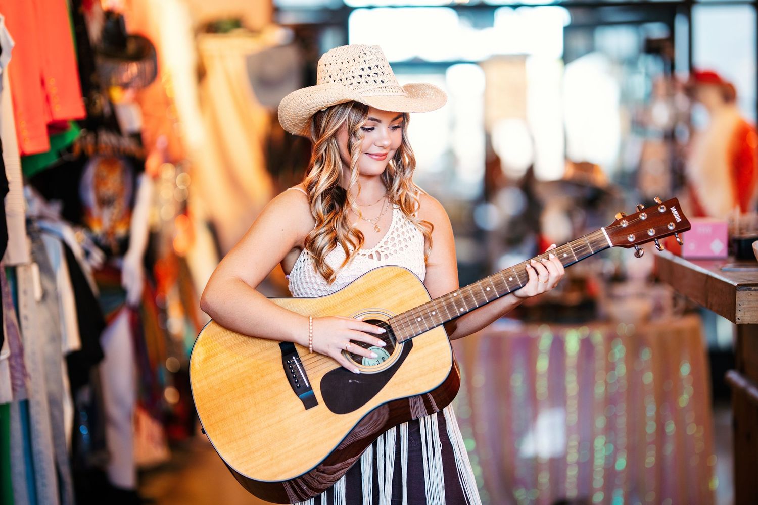 Musician performing with acoustic guitar in outdoor venue setting.Middle TN senior photographer.