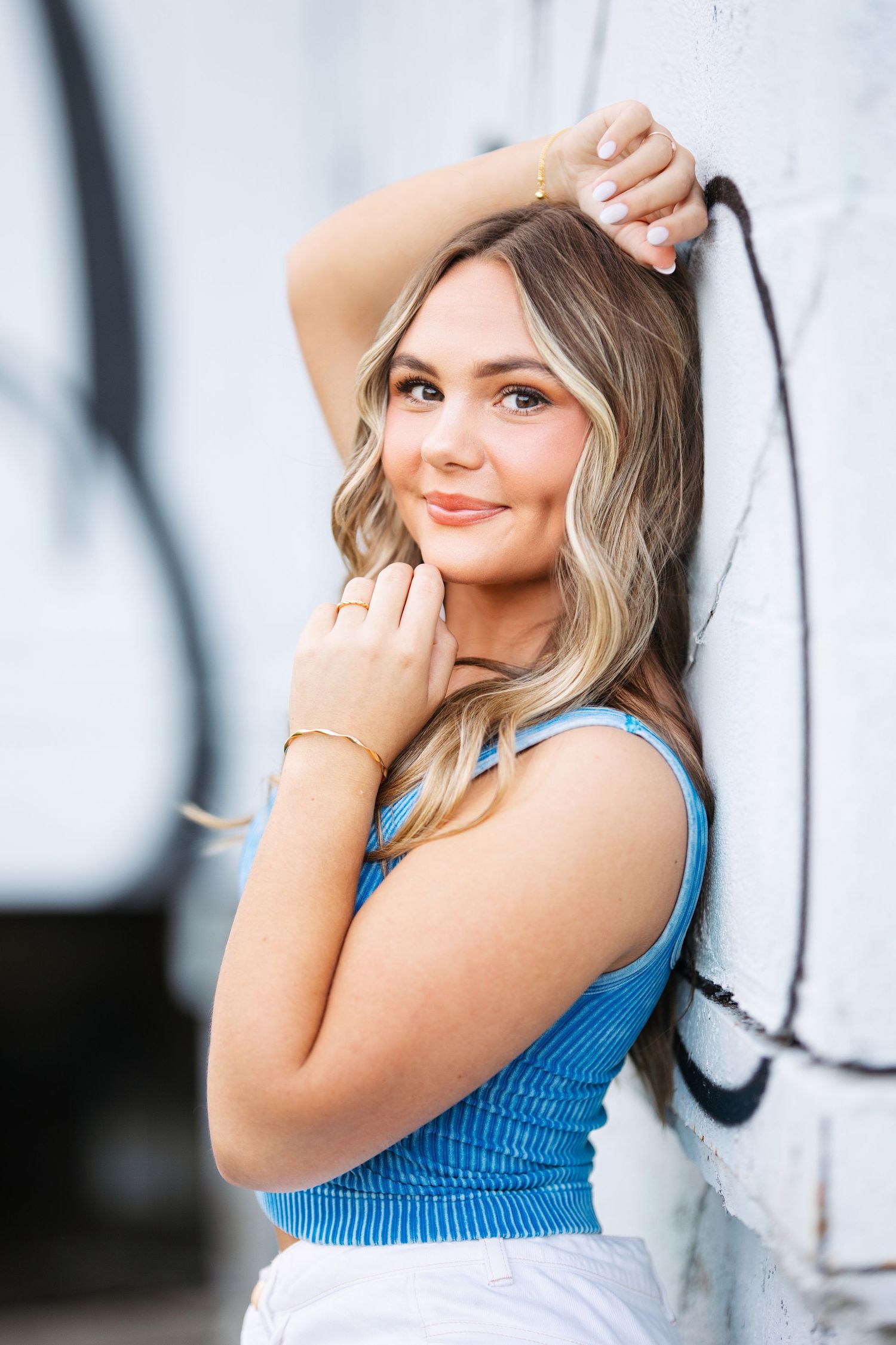 Portrait session against white backdrop featuring casual blue summer top. Middle TN senior photographer.
