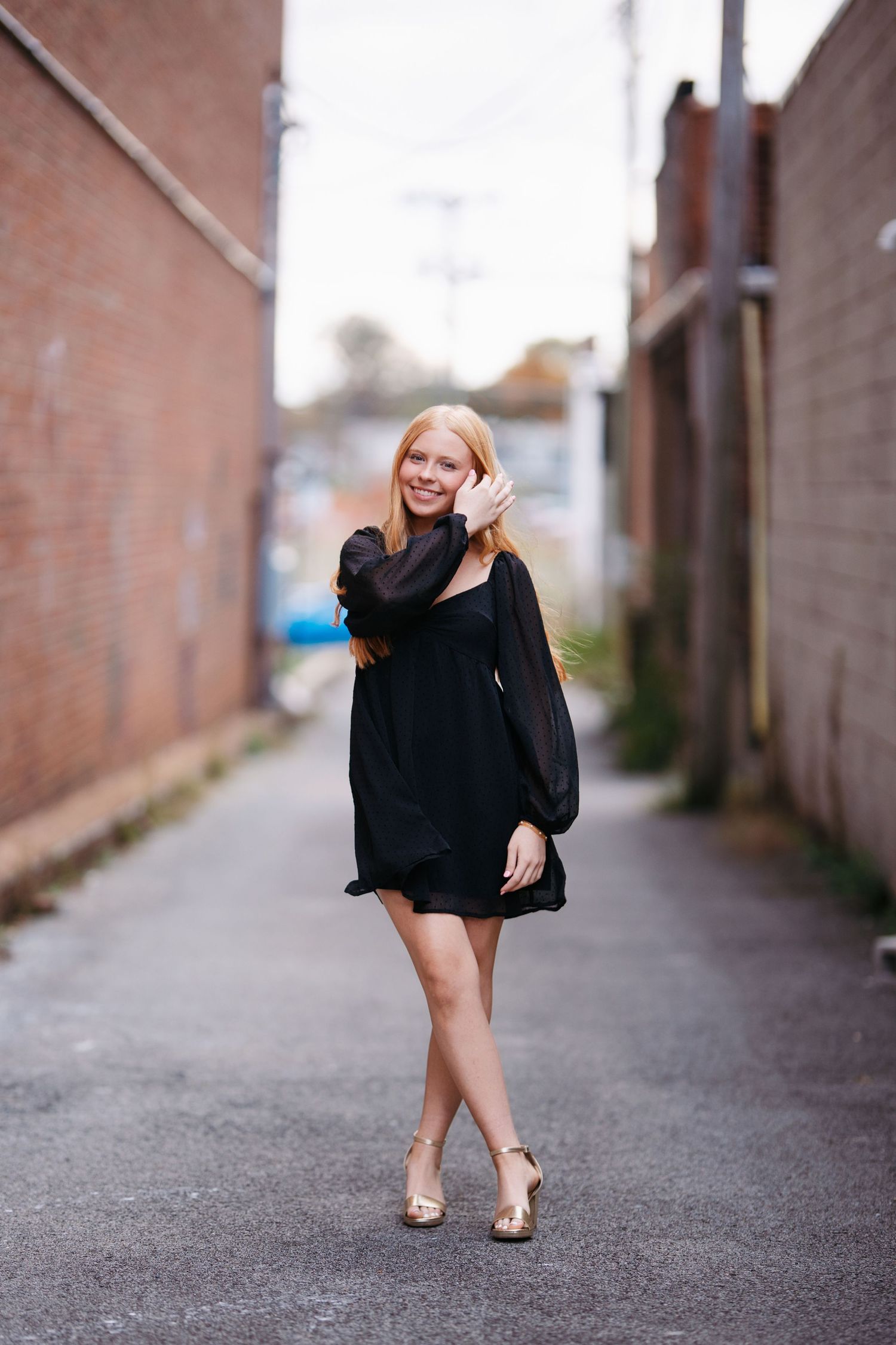 Fashion portrait series in an urban alley featuring a little black dress and nude heels. Middle TN senior photographer.