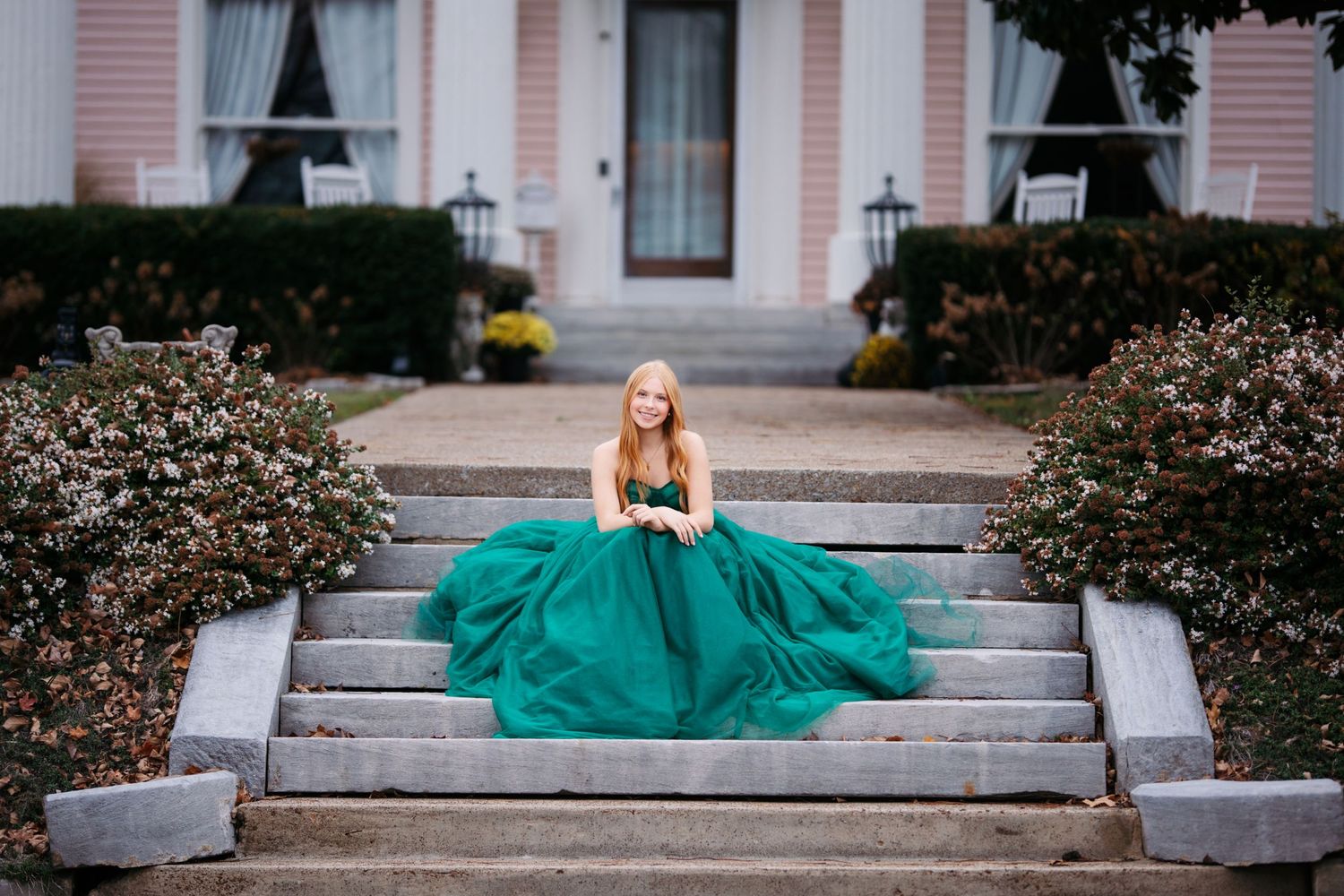 Elegant teal gown photoshoot on concrete steps with pink building backdrop. Middle TN senior photographer.