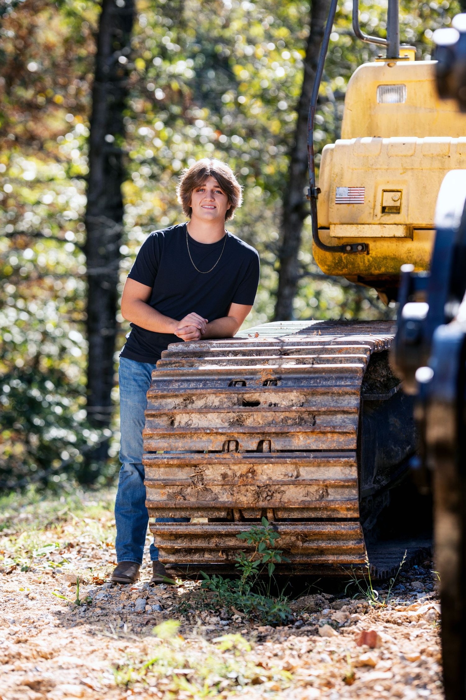Senior portrait session with rustic construction equipment in autumn setting.Middle TN senior photographer.