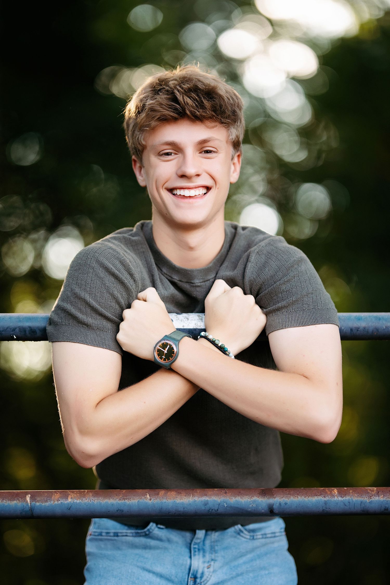 Portrait series showing a casual black t-shirt pose against a blurred natural background.Middle TN senior photographer.