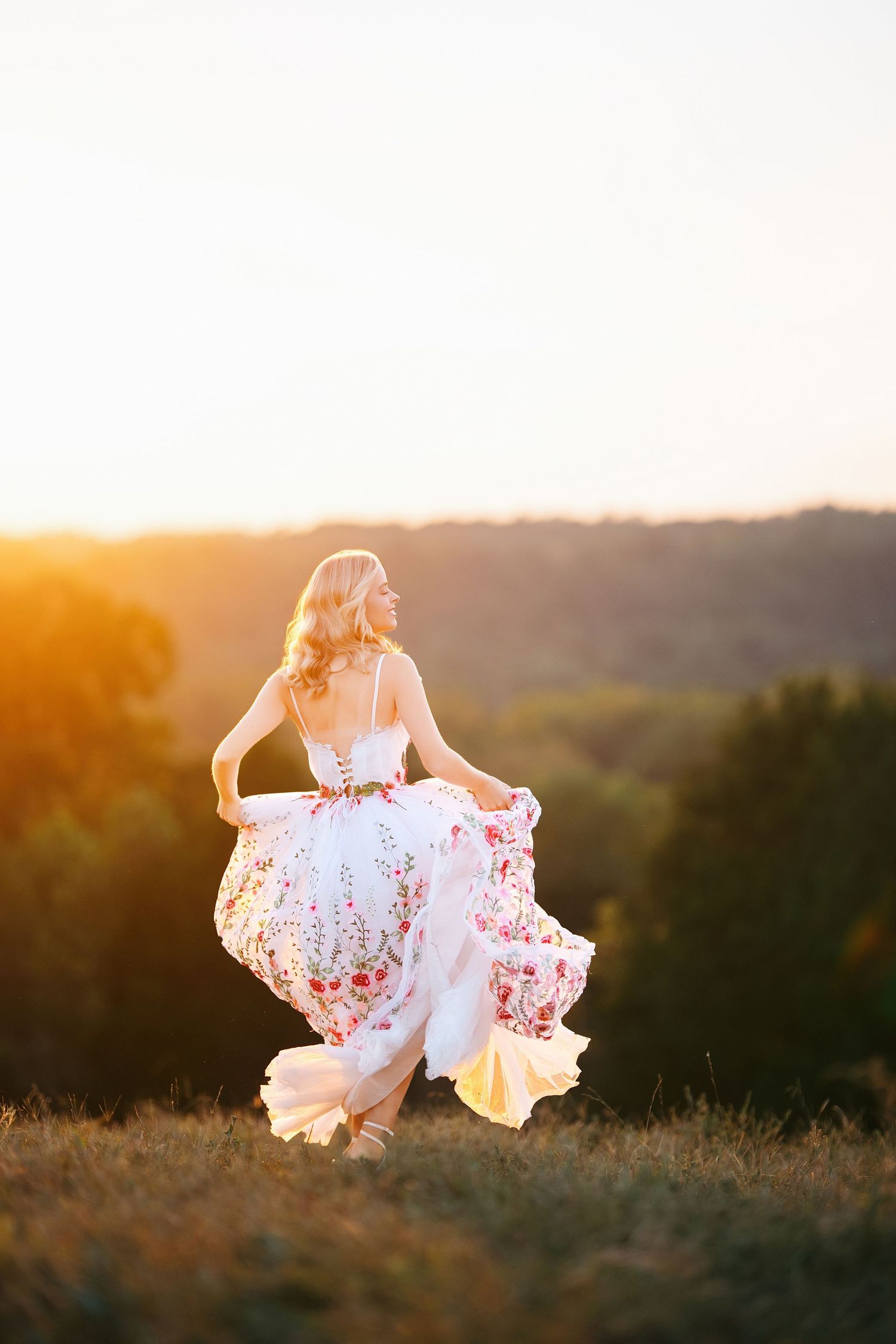Ethereal sunset portrait in white dress spinning in golden light. Middle TN senior photographer.
