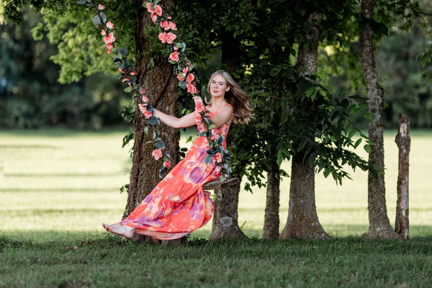 Pink flowering trees create romantic natural archway in lush garden setting. Middle TN Senior photographer