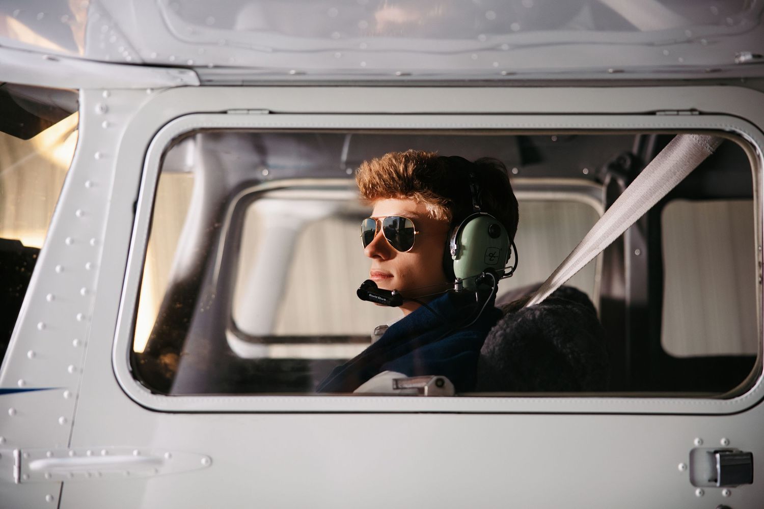 Interior view of small aircraft with senior guy in cockpit during flight. Middle TN senior photographer.