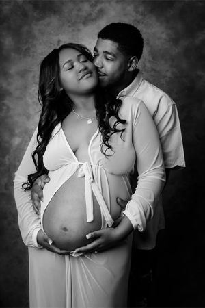 Black and white formal maternity portrait with mom and dad
