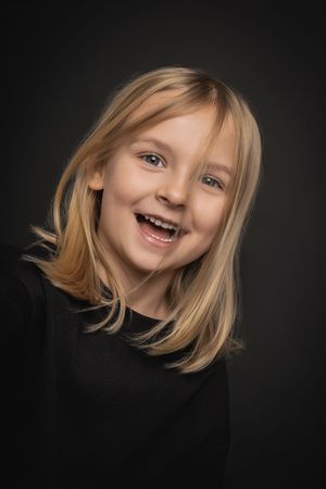 A series of expressive portrait shots showing joyful emotions against a dark background.