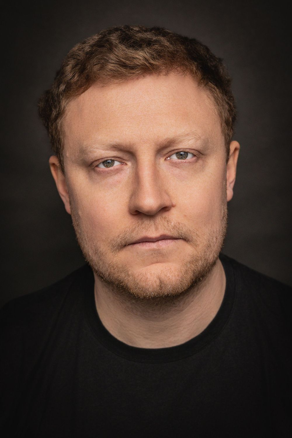 A dramatic series of dark portraits showing different angles of a person's face against a black background.