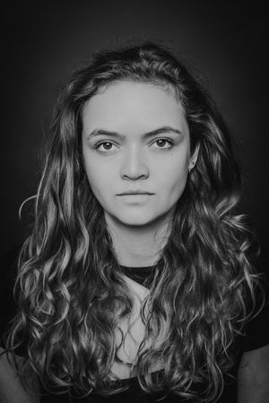 A dramatic black and white portrait series showing wavy dark hair and expressive features against a dark background.