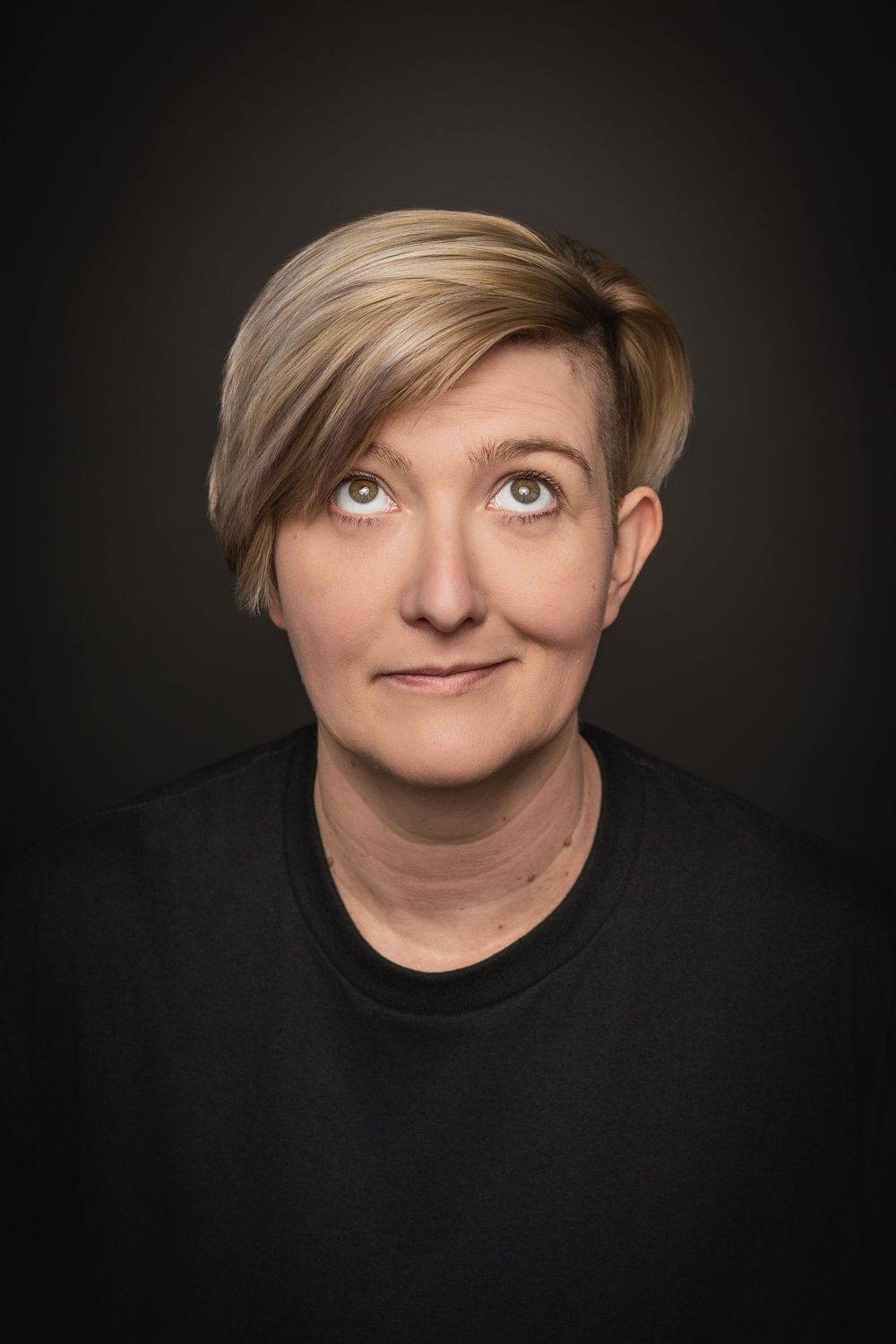A sequence of four portraits showing a playful expression with blonde hair and a hat against a dark background.